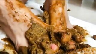 Woman lays down and plays in a pile of shit