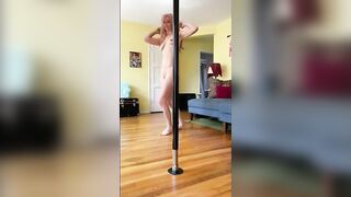 Woman grinds her ass on a pole in the living room