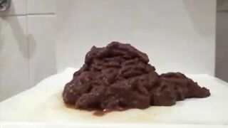 Woman shits on a piece of toilet paper on the floor