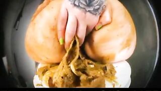 Woman uses her ass to play with shit on a plate
