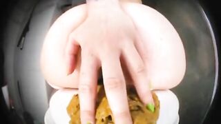 Woman uses her ass to play with shit on a plate