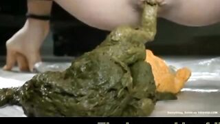 Woman poops giant shit into a plate on the floor