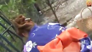 Girl in traditional dress taking a huge shit outside