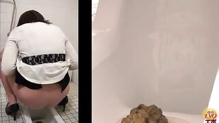 Woman takes a huge shit on the toilet in the bathroom