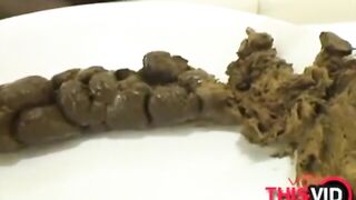 A big log of shit on a white plate ready to be eaten