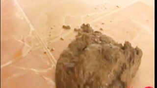 Girl squats and takes a load of shit on her thighs