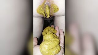 Woman pulls out a massive shit from her ass.