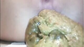 Woman drops a huge shit onto a piece of paper