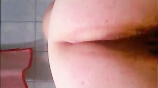 Slutty woman spreads her ass wide open while sitting on the toilet