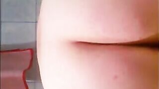 Slutty woman spreads her ass wide open while sitting on the toilet