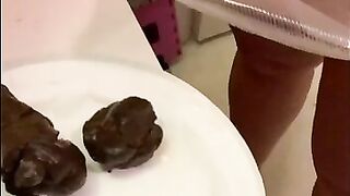 Girl stands over plate and shits on it