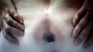 Spreading her butt cheeks wide opened while pooping