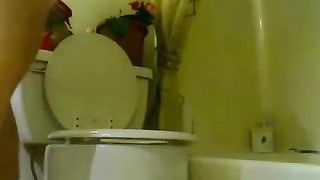 Girl takes a shit on the toilet with her pants around her ankles