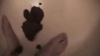 Brunette Japanese pooping in a plastic bucket