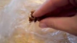 Amateur girl eating poop from a plastic bag