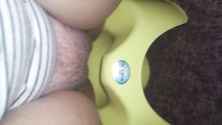 Shitting in a green potty