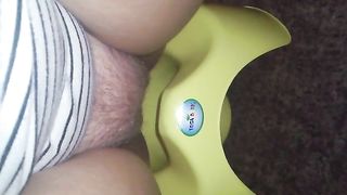 Shitting in a green potty