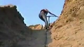 Hot college girl shitting in nature on a big rock