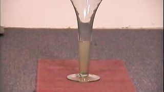 Blonde nurse peeing into a champagne glass