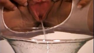 Blonde nurse peeing into a champagne glass