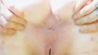 Spreading her cheeks to poop outdoor on a field