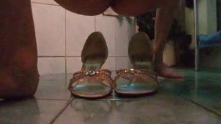 Shitting on her good gold sandals