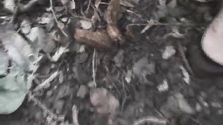 Young woman pooping in a public park