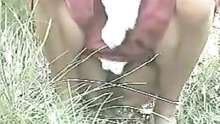 Hairy girl shitting on the grass outdoor