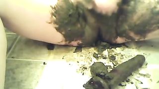 Chubby girl smearing black shit on her pussy