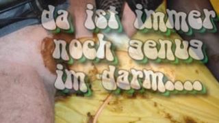 Male slave rubbing poop on his latex outfit