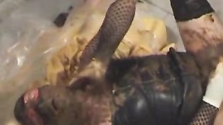 Male slave rubbing poop on his latex outfit