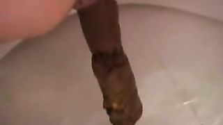 Sexy aunty shitting a very long brown turd