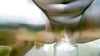 Fingering her pussy after peeing in a glass