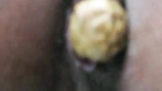 Nurse shitting a long yellow turd over a toilet