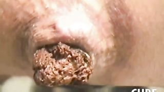 Claire shitting a hard turd on a newspaper