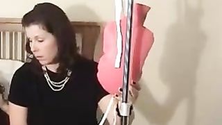 Mother giving enema to her daughter