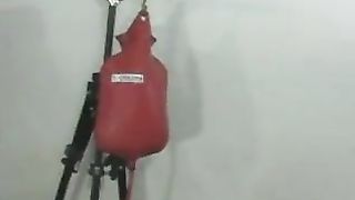 Male slave getting enema from nurse mistress