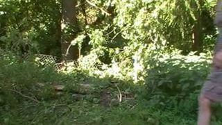 Skinny tattooed girl pooping in nature