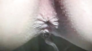 Young brunette peeing and pooping behind a building