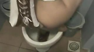 Hot brunette latina pooping on top of a toilet