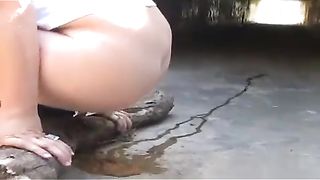Young girl shitting under a bridge