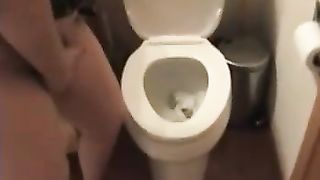Sexy chubby MILF pooping over the toilet