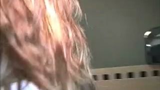 Young college girl using a public bathroom