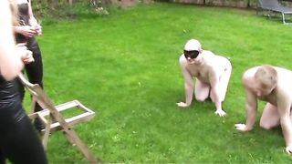 Two hot girls pooping on male slaves