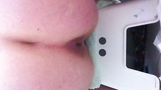 Mature chubby woman pooping on a white toilet