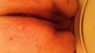 Fat woman pooping in toilet in close up