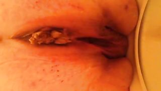 Fat woman pooping in toilet in close up