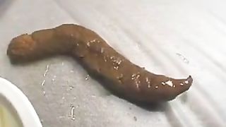 Young lady pooping while her boyfriend masturbates