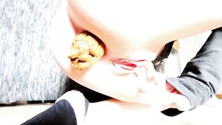 Young blonde babe pooping a huge turd