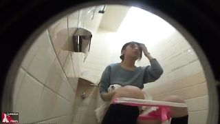 Sexy girl peeing in a public bathroom